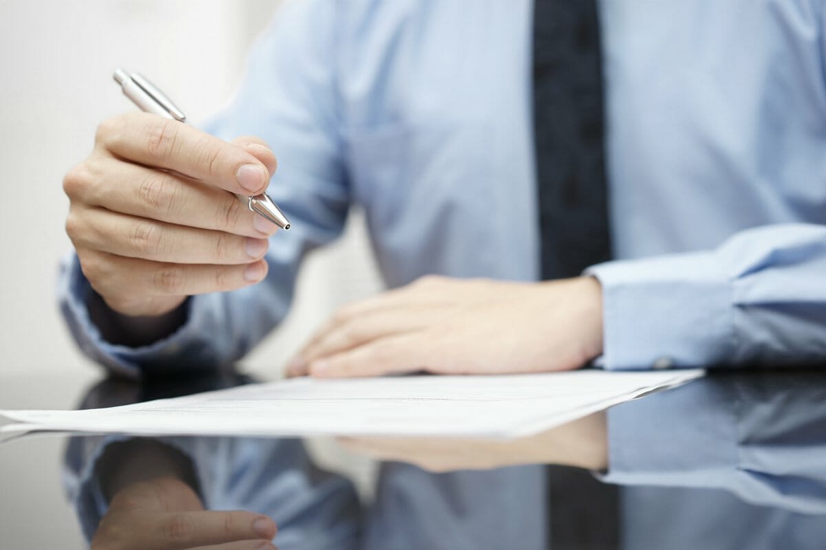man holding pen | IRS Form 5329 [For Retirement Savings And More] | Internal Revenue Service | what is form 5329
