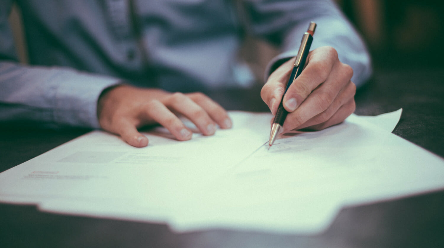 Featured | man writing on paper | What Are Tax Exemptions And What Qualifies As A Tax Exemption?