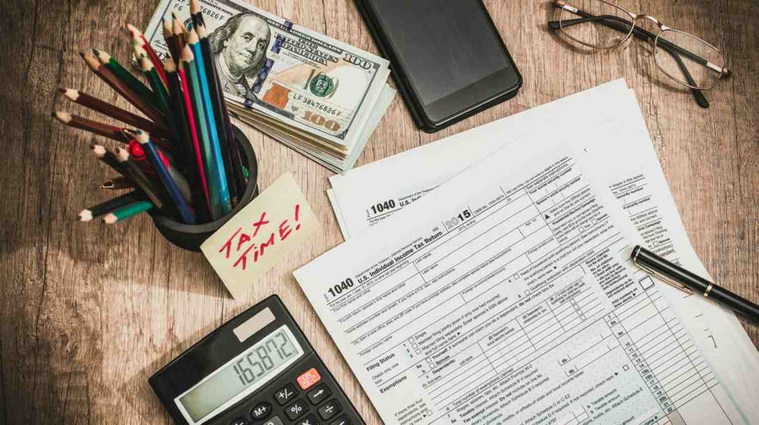 Featured | forms and money on the table | Tax Preparation Checklist To Take Control Of Your Tax Planning Early This Year