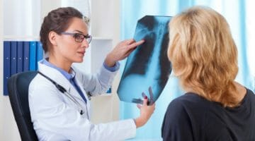 Featured | doctor shows xray to patient | No Health Insurance Penalty | Everything You Need To Know