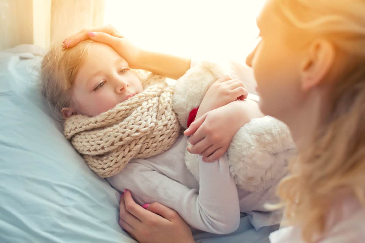 mother taking temperature of sick daughter | The Master List of All Types of Tax Deductions | types of tax deductions | types of deductions