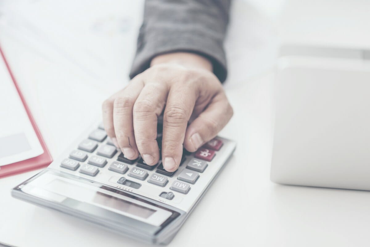 businessman using calculator | Internal Revenue Service | Tax Deductions and Tax Writeoffs Guide | Tax Writeoff Blog Roundup | What Is Tax Deductible?