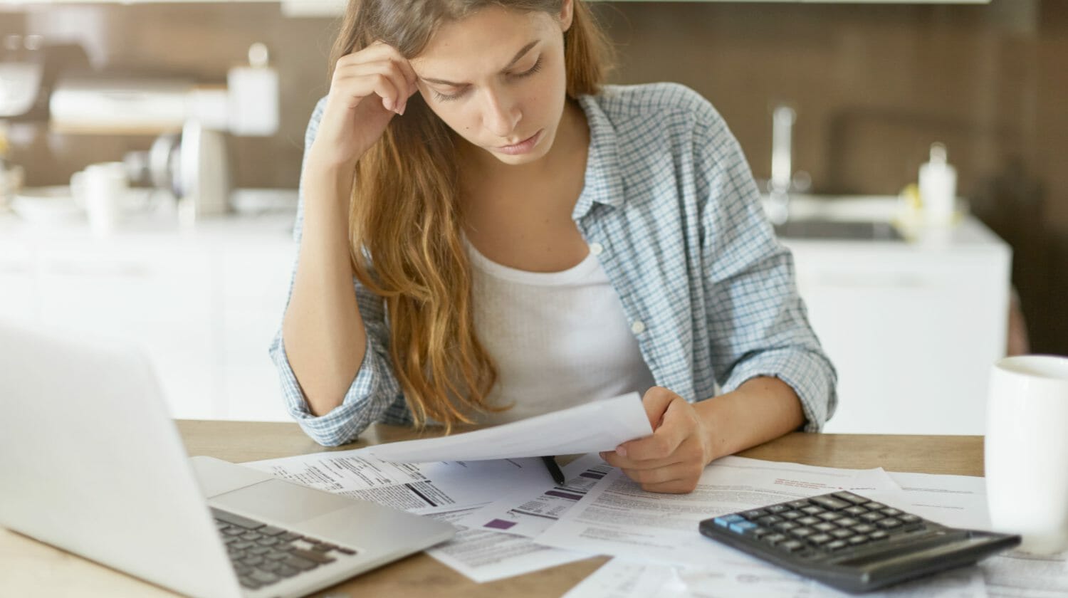 Feature | woman worried about bills | What To Do If You’re Flagged For A Tax Audit | taxpayers