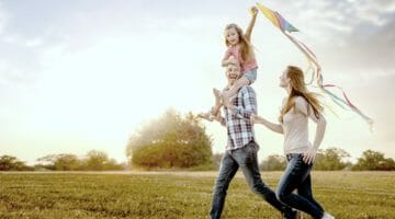 Feature | family running through field | How Does The Child Tax Credit Work? | additional child tax credit