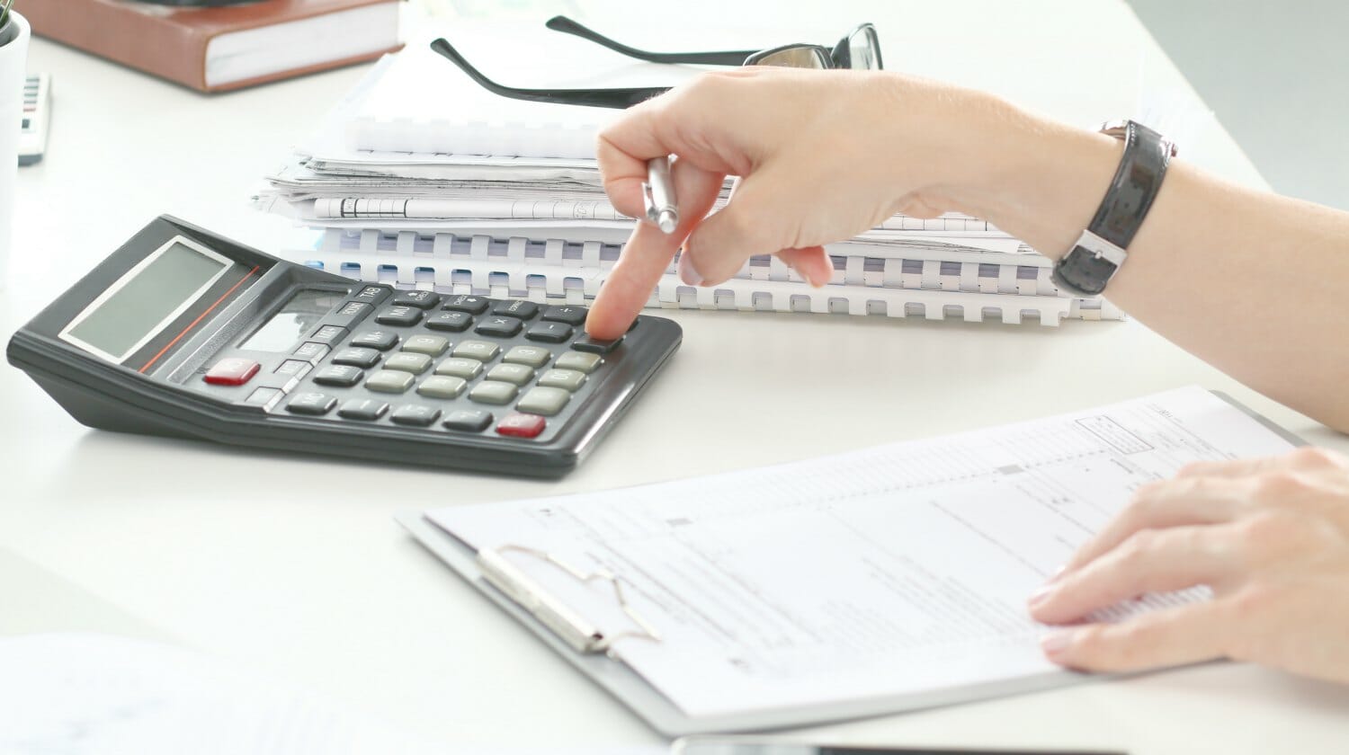 Feature | woman using calculator | What Is A Standard Tax Deduction? | personal exemption