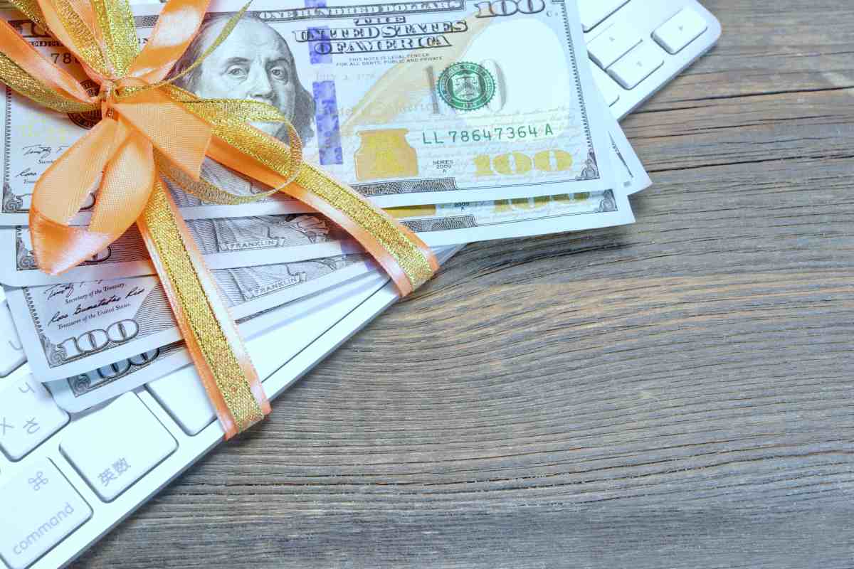money tied ribbon on computer keyboard | What Are the Gift Tax Limits This 2018? | gift tax limit 