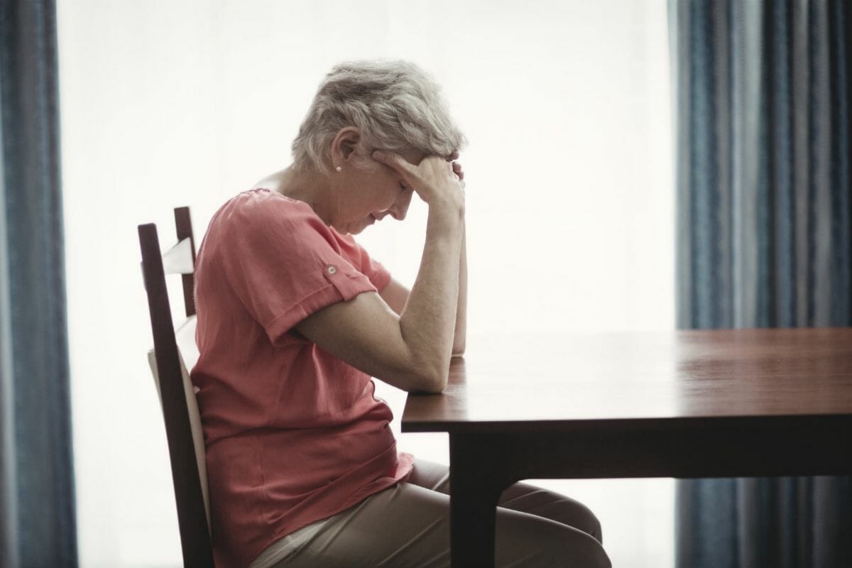 sad senior woman sitting in table | Failure To File Penalty: Facts You Should Know | Tax penalties