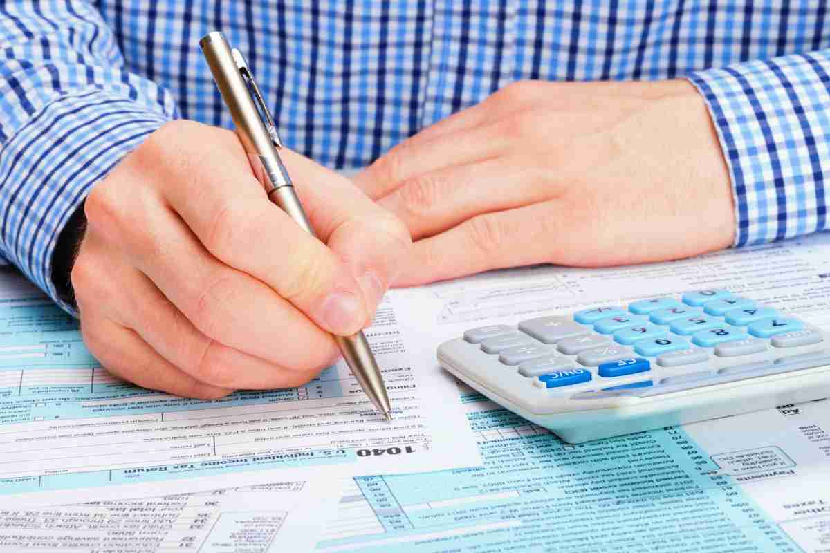 man filling out forms | What To Do When You Owe Back Taxes