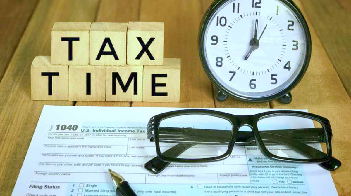 Tax form and wooden blocks with TAX TIME written on them | Things NOT To Say To The IRS If You Owe Back Taxes
