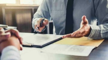 Feature | lawyer talking to client | Penalty Abatement: Factors That Can Qualify As Reasonable Cause | Reasonable cause for penalty abatement