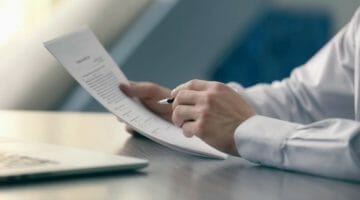 Feature | businessman reading documents | Types Of IRS Letters and Notices and What They Mean | irs letters