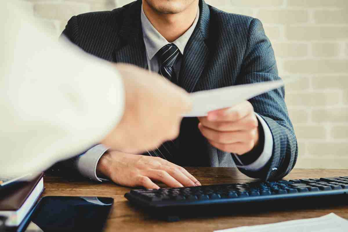 businessman passing documents | Penalty Abatement: Factors That Can Qualify As Reasonable Cause | Reasonable cause letter