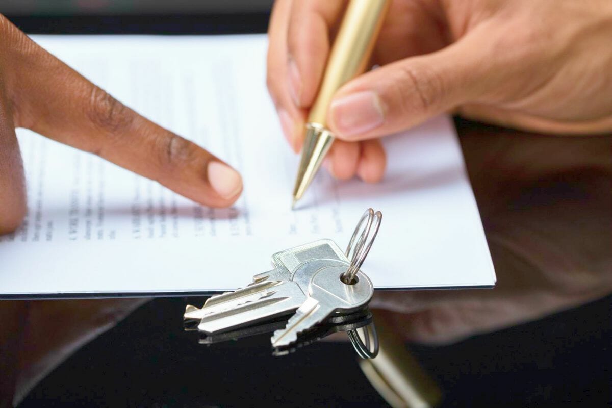 persons hand signing contract keys | Most Common Types Of Tax Liens | Tax liens