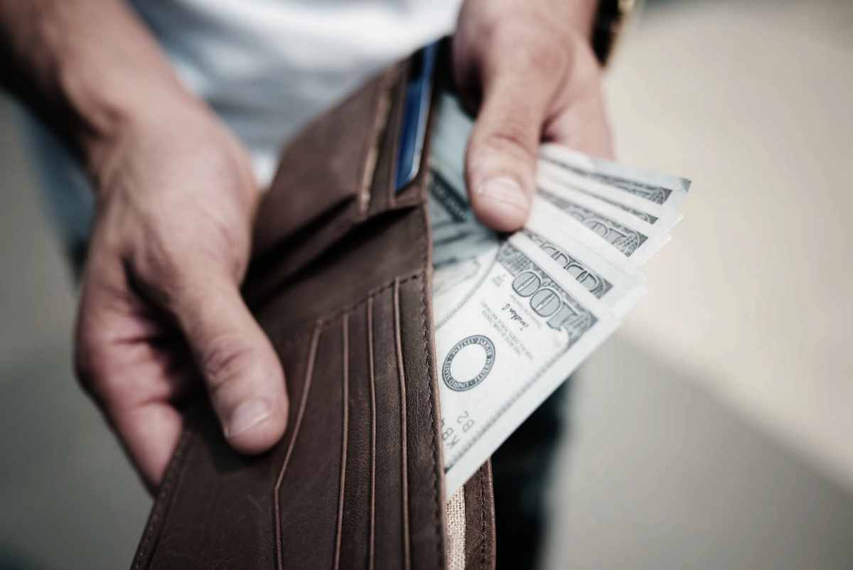 man holding out money | What Is A Tax Lien? | FAQs | federal tax lien