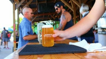 Feature | man holding glass of beer | What Is A Sin Tax? | sin tax definition