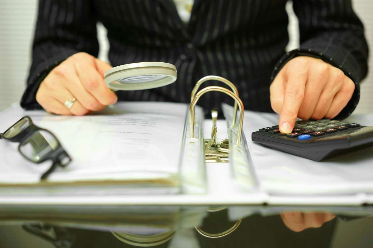 accountant checking documents | IRS Penalties You Could Be Facing After An Audit | tax audit