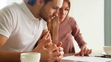 Feature | couple reading document | Appealing Your Rejected Or Terminated IRS Installment Agreement | what if i owe taxes and can't pay