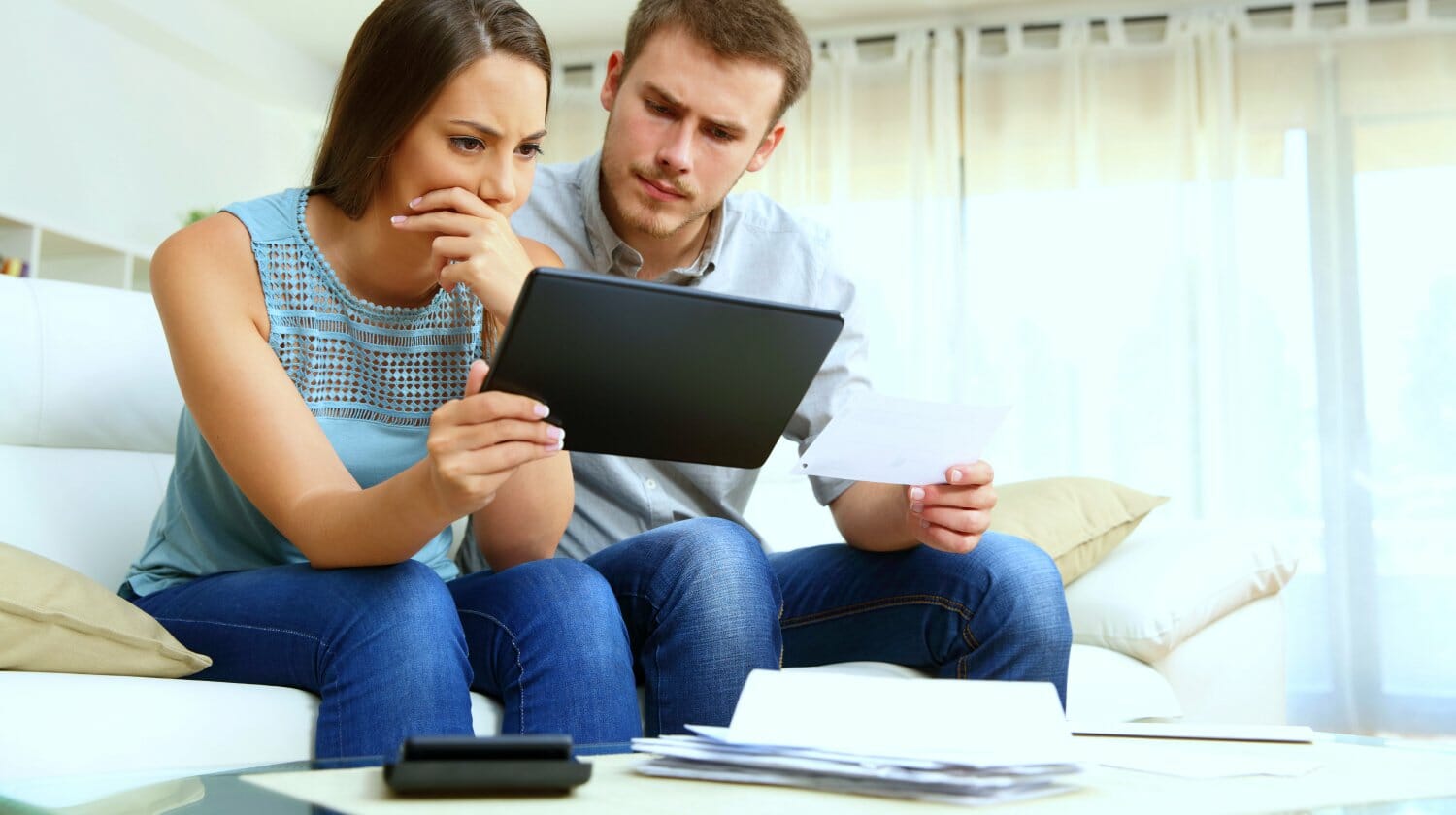 Feature | couple worried about bills | Tax Worries You May Have And The Solutions For Each [FAQs]