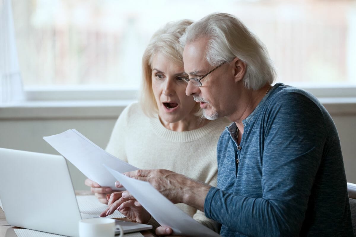 senior couple reading documents | Can You Go To Prison For Not Paying Taxes? | back taxes