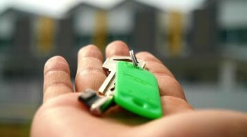 Feature | hands holding keys | How To Get Your Home Back After A Tax Sale | delinquent taxes