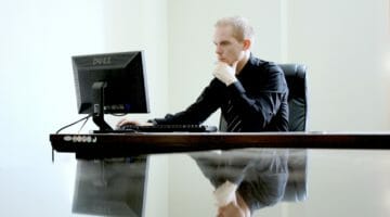 Featured | businessman looking at his computer | IRS Audit Triggers You Need To Know If You Are Self Employed | business deductions for self employed