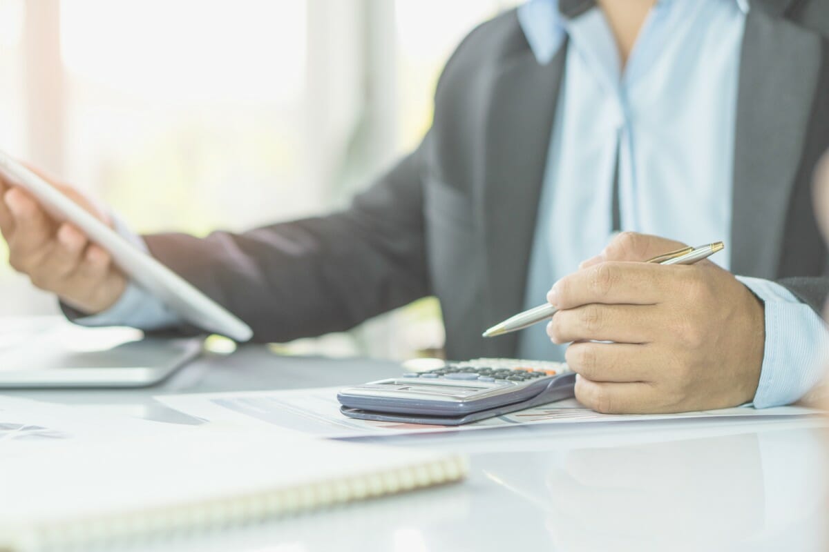 businessman using calculator | Small Business Taxes Owners Must Pay | local business tax