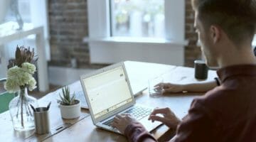 Feature | man using his laptop | How Do Tax Liens Affect Your Small Business? | irs tax lien