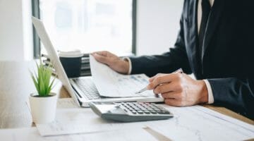 Featured | businessman working | What Are Deferred Tax Liabilities? | deferred tax liability